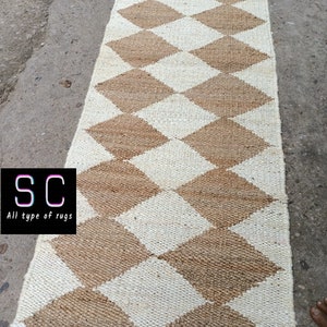 May include: A brown and white checkered jute rug with a diamond pattern. The rug is made of natural fibers and has a rustic look.