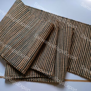 May include: Four striped woven mats in shades of brown and green. The mats are made of natural fibres and have a rustic look.