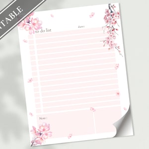 May include: Printable to-do list with a pink background and a floral design featuring pink blossoms. The text "to do list" is at the top of the page. The words "date" and "note" are also included.