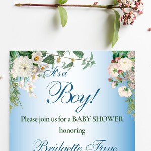 May include: It's a Boy! Baby shower invitation with a blue background and white flowers. The text reads "It's a Boy!" and "Please join us for a Baby Shower honouring Bridgette Faye".