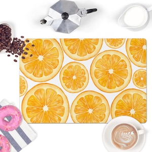 May include: A white rectangular kitchen mat with a watercolor design of orange slices. The mat features a variety of orange slices in different sizes and positions.