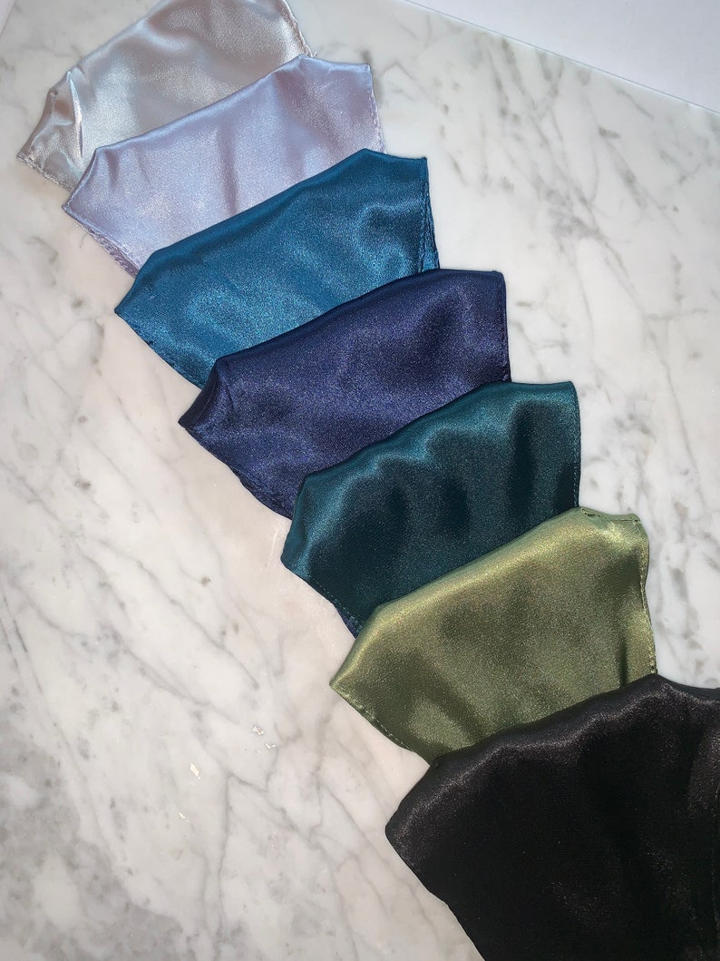 May include: Seven satin fabric face masks in various colors, including light gray, teal, navy blue, dark green, olive green, and black.