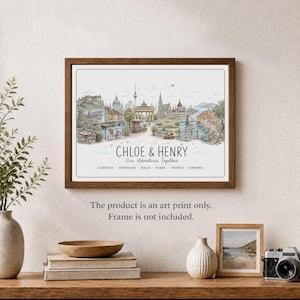 May include: A framed art print featuring a watercolour-style illustration of a European cityscape with the text CHLOE & HENRY Our Adventures Together and a list of cities including Edinburgh, Copenhagen, Berlin, Vienna, Budapest, and Dubrovnik.
