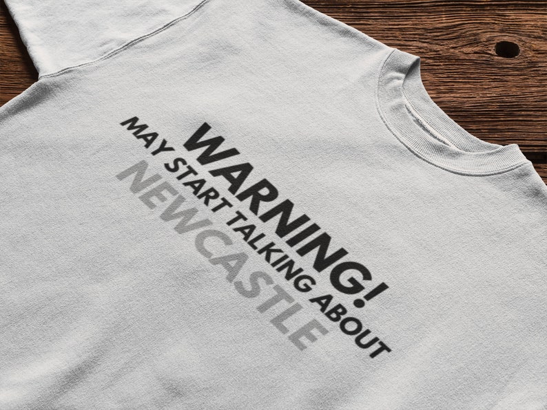 May include: A gray sweatshirt with the text "WARNING! MAY START TALKING ABOUT NEWCASTLE" printed on the front.