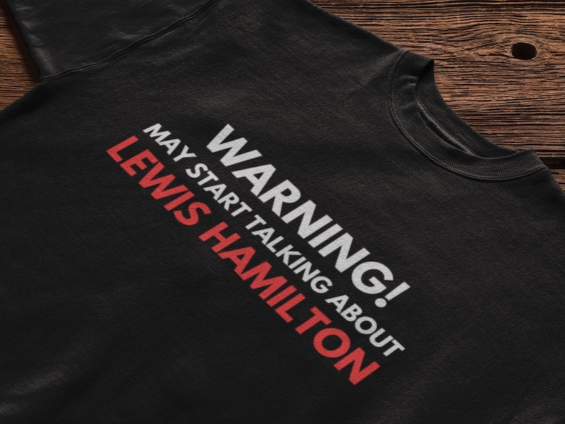 May include: Black sweatshirt with white text that reads "WARNING! MAY START TALKING ABOUT LEWIS HAMILTON".