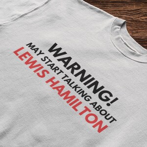 May include: A gray sweatshirt with the text "WARNING! MAY START TALKING ABOUT LEWIS HAMILTON" printed on the front.