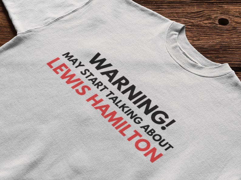 May include: A gray sweatshirt with the text "WARNING! MAY START TALKING ABOUT LEWIS HAMILTON" printed on the front.