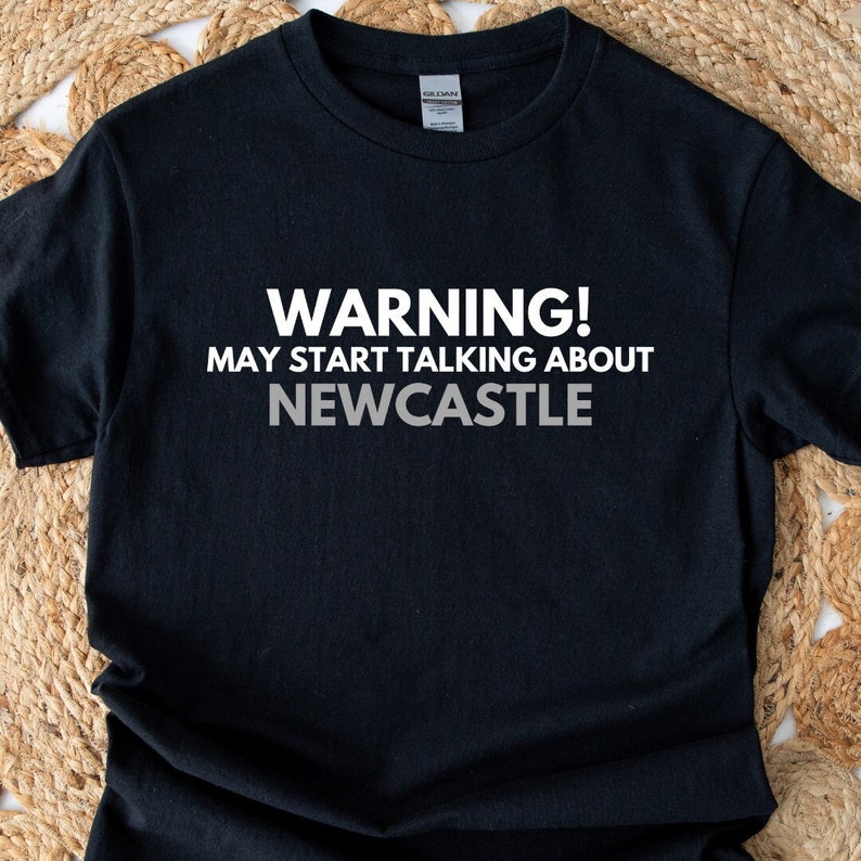 May include: Black t-shirt with white text that reads "WARNING! MAY START TALKING ABOUT NEWCASTLE".