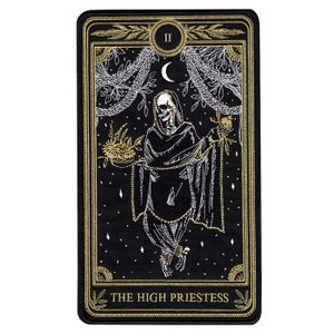 May include: A black embroidered patch with gold accents depicting a skeletal figure in a robe holding a pomegranate and a basket of flowers. The patch features the text "THE HIGH PRIESTESS" and the Roman numeral "II".