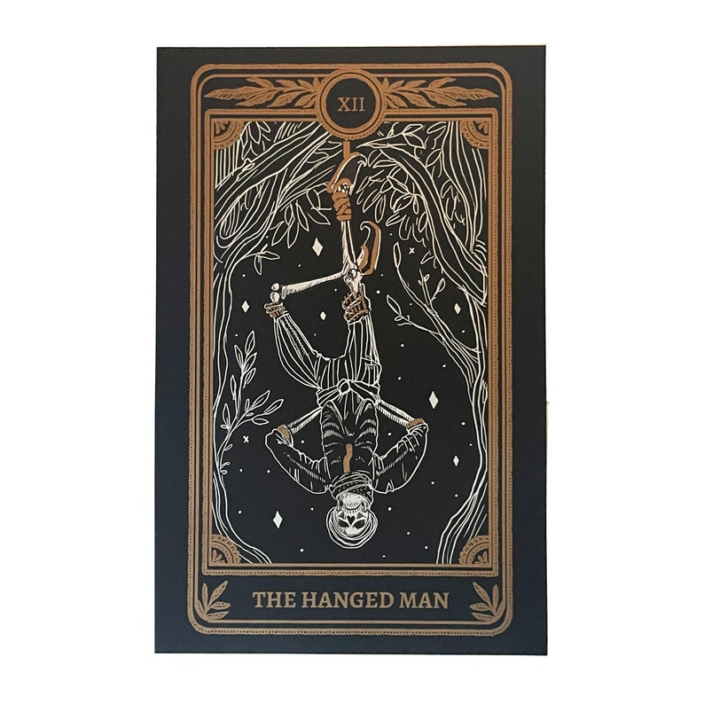 the hanged man tarot print on altar with altar cloth, skull, and candle. Design from the Marigold Tarot deck