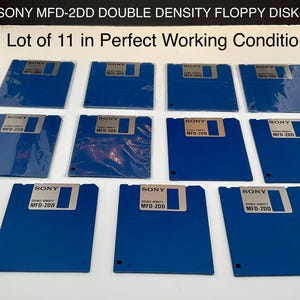 May include: A collection of eleven blue Sony MFD-2DD double density floppy disks. Each disk has a silver label with black text. The text "SONY MFD-200" is visible on each disk. The text "Lot of 11 in Perfect Working Condition" is also visible.