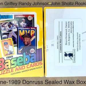 May include: A yellow 1989 Donruss Baseball puzzle and cards box, featuring Warren Spahn. The box includes baseball cards with players like Cal Ripken and Kirby Puckett. The box is unopened and sealed.