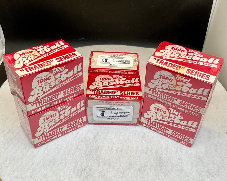 May include: Three unopened boxes of 1986 Topps "Traded" Series Baseball cards. The boxes are red and white with the Topps logo and the words "1986 Topps Baseball" and "Traded Series".