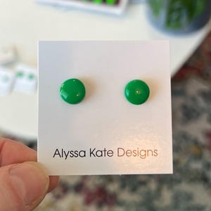 May include: A pair of green round stud earrings on a white card with the text "Alyssa Kate Designs".