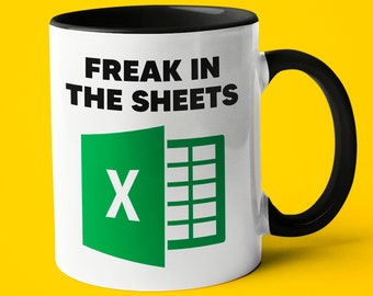 May include: White coffee mug with a black rim and handle. The mug has a green and black Excel logo and the text "Freak in the sheets".