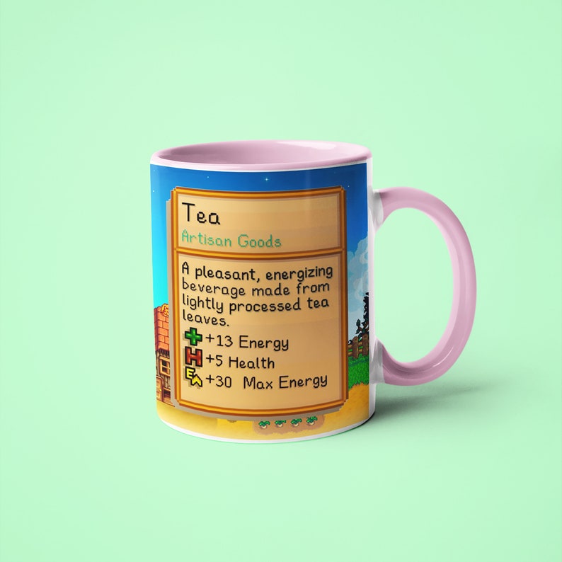 Op de afbeelding: Een roze en witte mok met een gepixelde afbeelding van een videogame-item genaamd "Thee". De afbeelding toont de tekst "Thee, Ambachtelijke producten, Een aangenaam, energiek drankje gemaakt van licht verwerkte theebladeren. +13 Energie +5 Gezondheid +30 Maximale energie".