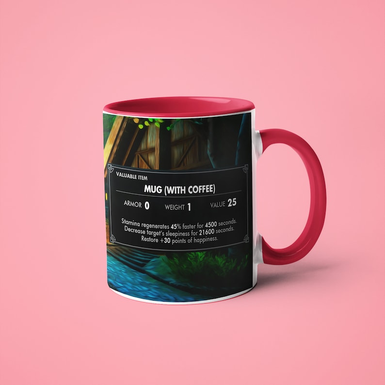 May include: A white ceramic mug with a red rim, featuring a video game-style graphic of a mug with coffee. The text on the mug reads "VALUABLE ITEM MUG (WITH COFFEE) ARMOR 0 WEIGHT 1 VALUE 25 Stamina regenerates 45% faster for 4500 seconds. Decrease target's sleepiness for 21600 seconds. Restore +30 points of happiness."