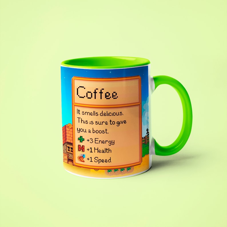 May include: A green and white coffee mug with a pixelated design inspired by the video game Stardew Valley. The mug features the text "Coffee" and a description of the drink's effects: "It smells delicious. This is sure to give you a boost. +3 Energy +1 Health +1 Speed"