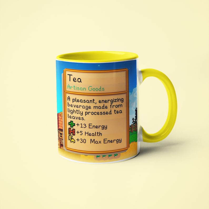 Op de afbeelding: Een gele en witte mok met een gepixelde afbeelding van een videogame-item genaamd "Thee". De tekst luidt "Ambachtelijke goederen" en beschrijft het item als een "prettig, energiek drankje gemaakt van licht verwerkte theebladeren". De afbeelding toont ook de statistieken van het item: +13 Energie, +5 Gezondheid en +30 Maximale Energie.