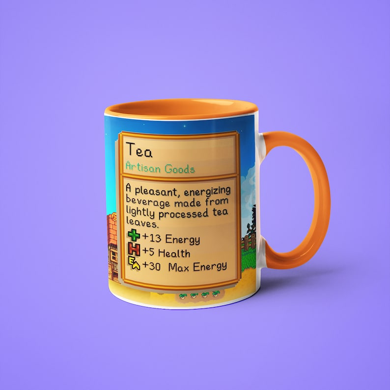 Op de afbeelding: Een mok met een oranje handvat en een ontwerp van een videogame-item genaamd "Thee" met de tekst "Artisan Goods" en statistieken voor energie, gezondheid en maximale energie.