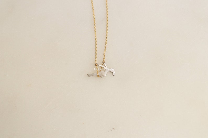 Dainty Girl on Swing Necklace, Two Tone, Play Time Childhood Memories, Nostalgic Gold Minimalist Jewelry, Perfect Gym Teacher, Friend Gift May include: A gold chain necklace with a silver pendant of a person swinging on a swing