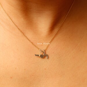 Dainty Girl on Swing Necklace, Two Tone, Play Time Childhood Memories, Nostalgic Gold Minimalist Jewelry, Perfect Gym Teacher, Friend Gift May include: A gold chain necklace with a pendant of a woman in a yoga pose. The pendant is made of silver and is hanging from the chain. The text 'Isla Flora' is visible on the pendant.