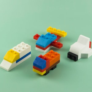 May include: Four colorful toy vehicles made of plastic building blocks. The vehicles include a blue and red airplane, a white and yellow train, a white and red car, and an orange and red truck.