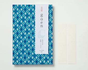 May include: A set of Japanese stationery featuring a blue patterned cover with white accents. The cover has the word "goen" in white text. Two white rectangular stickers are next to the stationery.