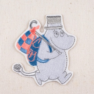 May include: Embroidered patch featuring a light gray cartoon character with a top hat and a backpack. The backpack is blue with a red and orange checkered pattern. The patch has a white border.