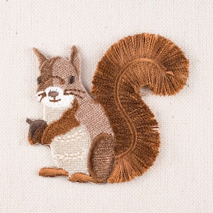 May include: Embroidered brown squirrel patch with a fluffy tail. The squirrel is holding a nut in its paws.