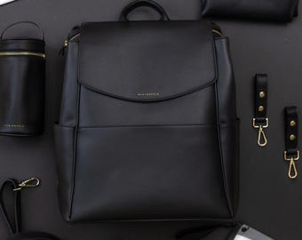Vegan Leather Diaper Bag Backpack: Designer Style, 15 Pockets, Laptop Pocket and Included Accessories