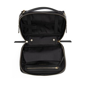 May include: Black leather travel makeup bag with gold hardware and a zipper closure. The bag is open and the interior is visible.
