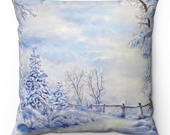 May include: Square cushion with a winter scene painting. The artwork shows snow-laden trees, a wooden fence, and a tranquil, snow-covered field beneath a cloudy sky. The colour scheme is mainly blue and white.