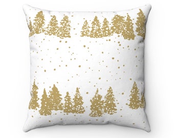 May include: Square white cushion with a gold forest design. The cushion features a repeating pattern of stylized pine trees along the top and bottom edges, with gold speckles scattered across the white background.