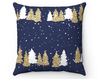 May include: Square cushion featuring a navy blue backdrop with a repeating pattern of gold and white Christmas trees. The trees are arranged in rows along the top and bottom edges, with white dots scattered across the navy blue field.