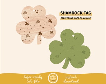 May include: Two shamrock shaped tags, one in a light brown wood grain pattern and one in a green color. Both tags have a hole at the top and are decorated with small shamrocks, hearts, rainbows, and horseshoes.
