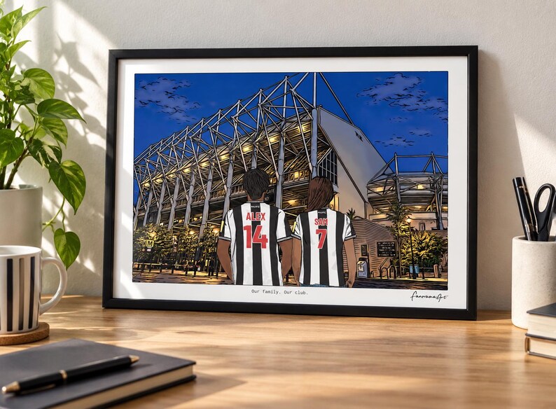 May include: A framed art print depicting a stadium at night with two individuals in black and white striped jerseys standing in the foreground. The jerseys feature the names Alex and Sam with the numbers 14 and 7. Text reads Our Family. Our club.