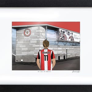 May include: A framed illustration of a person wearing a red and white striped jersey with the name CHARLIE and number 11 on the back, standing before the Gtech Community Stadium. The text Our club. Our memories. is printed at the bottom.