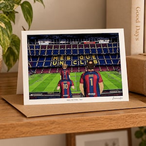 May include: A greeting card featuring an illustration of a soccer stadium with the text M&Eacute;S QUE UN CLUB on the seating. Three figures in blue and red jerseys stand on the field, with the text Happy Birthday, Dad! printed below.