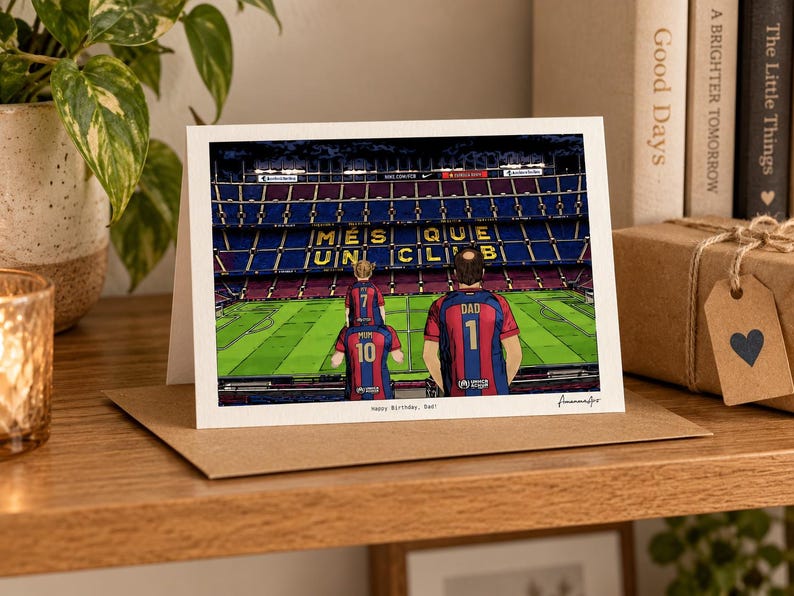 May include: A greeting card featuring an illustration of a soccer stadium with the text M&Eacute;S QUE UN CLUB on the seating. Three figures in blue and red jerseys stand on the field, with the text Happy Birthday, Dad! printed below.