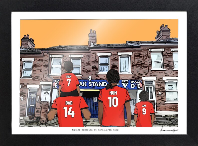 May include: A framed illustration of a family wearing red soccer jerseys with names and numbers on the back, standing before a brick building. The jerseys read Max 7, Dad 14, Mum 10, and Ava 9. The text below reads Making memories at Kenilworth Road.