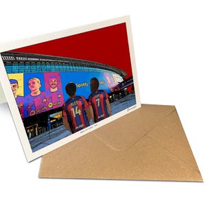 May include: A folded greeting card featuring a colorful illustration of the Spotify Camp Nou stadium with players wearing red and blue jerseys. The back of the card is white, and it is accompanied by a plain brown paper envelope for mailing.