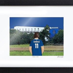 Bordered A4 Everton print in a black frame, showing Charlie, number 11, and Always a Blue. The border is part of the printed paper.