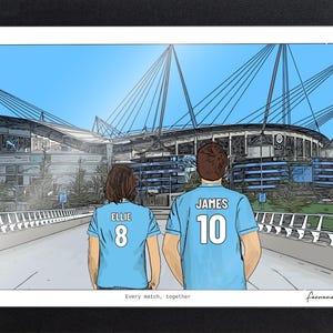 May include: A framed illustration of two people from behind wearing light blue soccer jerseys with the names Ellie and James and numbers 8 and 10 printed on the back. They stand before a large stadium under a clear blue sky. Text reads Every match, together.