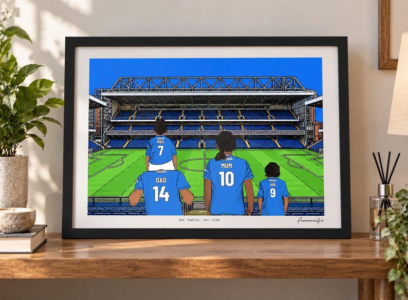 May include: A framed digital illustration of a family of four wearing blue soccer jerseys with names and numbers on the back, standing in a stadium. The jerseys are labeled Max 7, Dad 14, Mum 10, and Ava 9. The text Our family. Our club. is printed below.