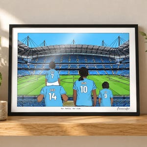 May include: A framed illustration of a family of four wearing light blue soccer jerseys with names and numbers on the back, standing in a large stadium. The text "Our family. Our club." is printed at the bottom center of the artwork.