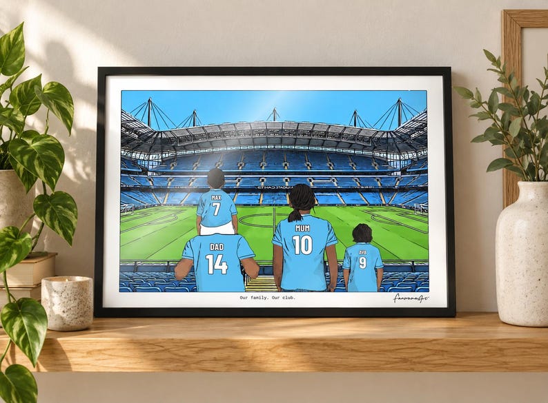 May include: A framed illustration of a family of four wearing light blue soccer jerseys with names and numbers on the back, standing in a large stadium. The text "Our family. Our club." is printed at the bottom center of the artwork.