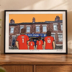 May include: A framed illustration depicting four people from behind, wearing red soccer jerseys with names and numbers. The jerseys read DAD 1, LEO 9, MIA 7, and MUM 10. They stand before a brick building labeled OAK STAND. The text Our family. Our club. is printed at the bottom.
