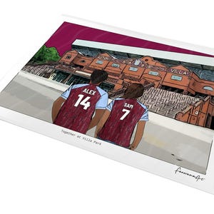 May include: A digital illustration print featuring two individuals wearing claret and blue soccer jerseys with the names ALEX 14 and SAM 7 on the back, standing before the Aston Villa stadium. The text Together at Villa Park is printed below.