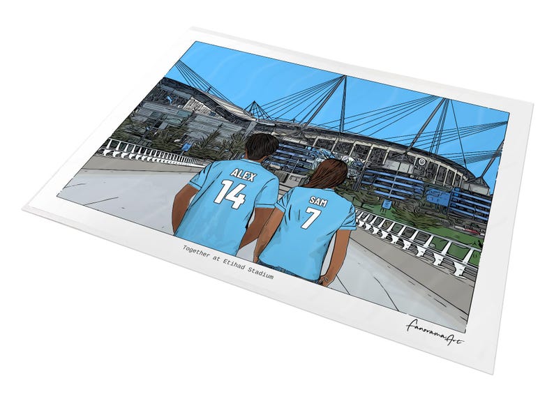 May include: A digital illustration print showing two individuals from behind, wearing light blue jerseys with the names ALEX 14 and SAM 7, standing before Etihad Stadium. The text Together at Etihad Stadium is printed below the figures.